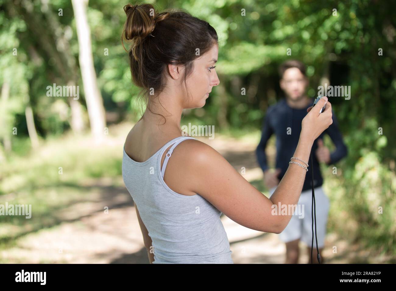 Smiling male trainer timing hi-res stock photography and images - Alamy