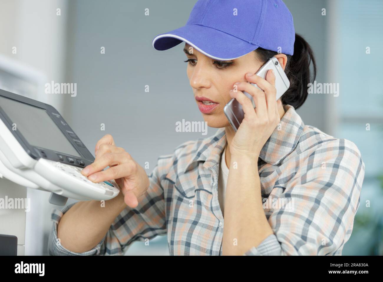 young female technician fixing a printer Stock Photo