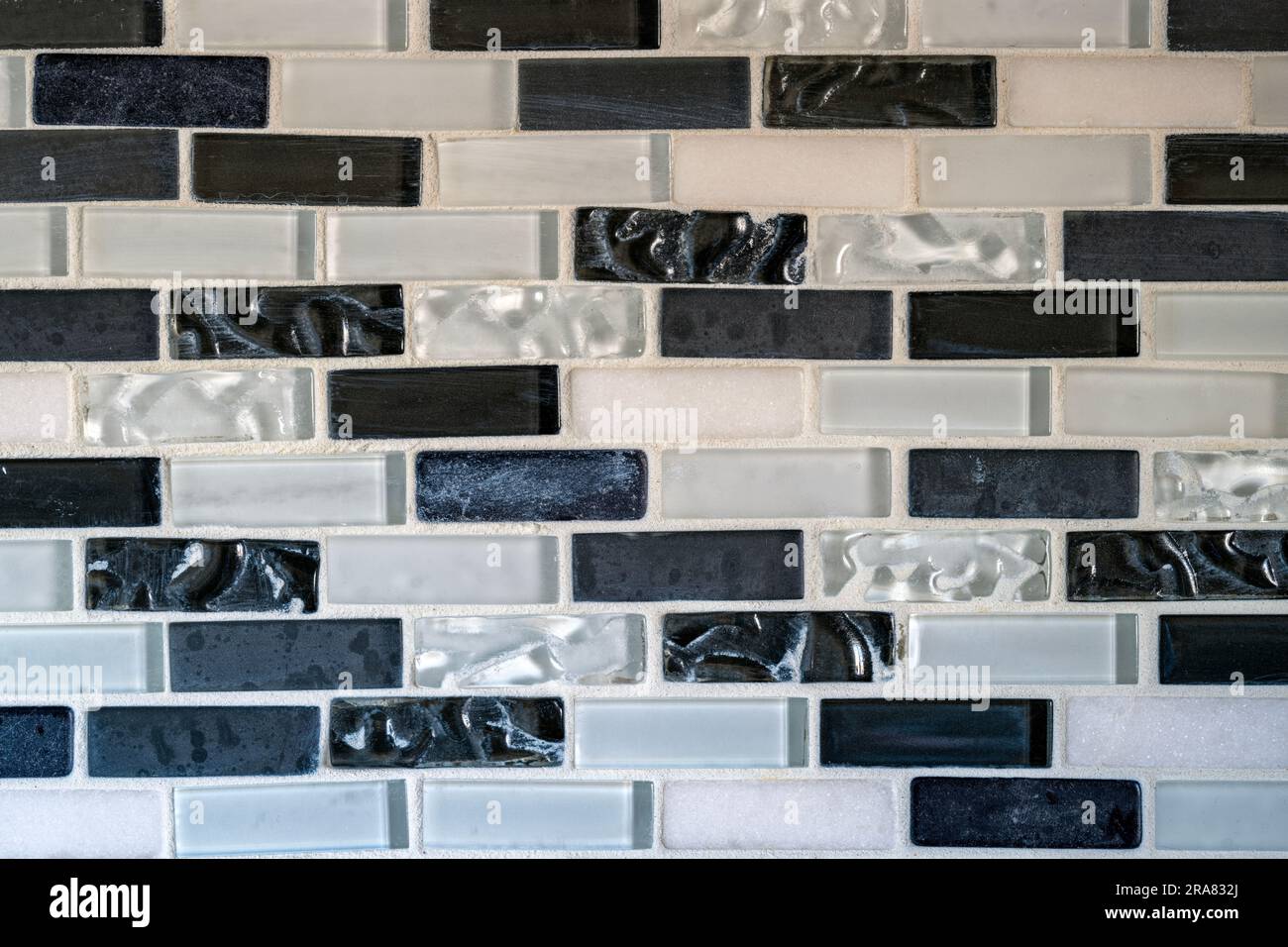 Black and white tiles in a rectangular pattern of an interior kitchen