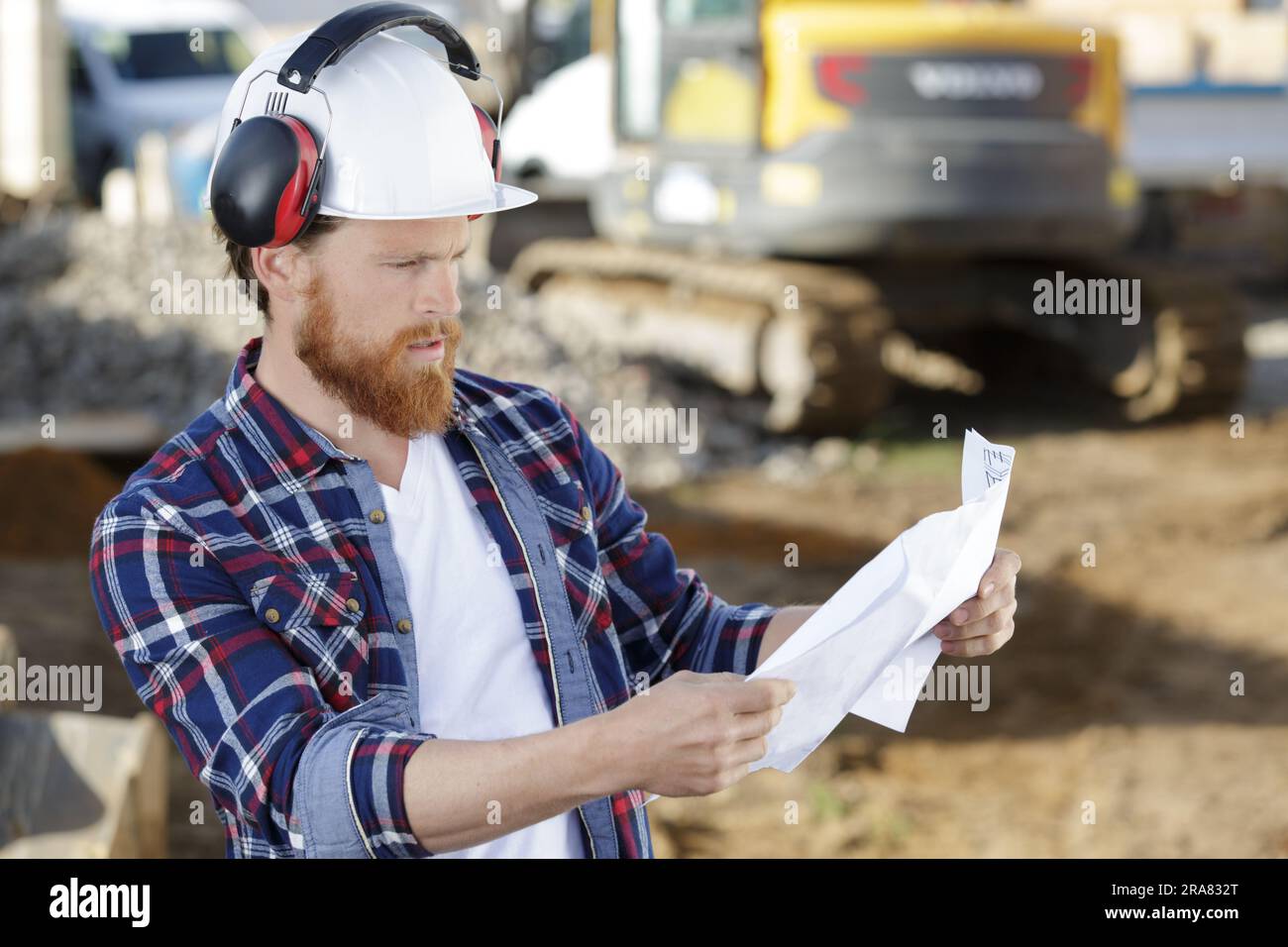 civil engineer or architect on construction site checking plan Stock Photo