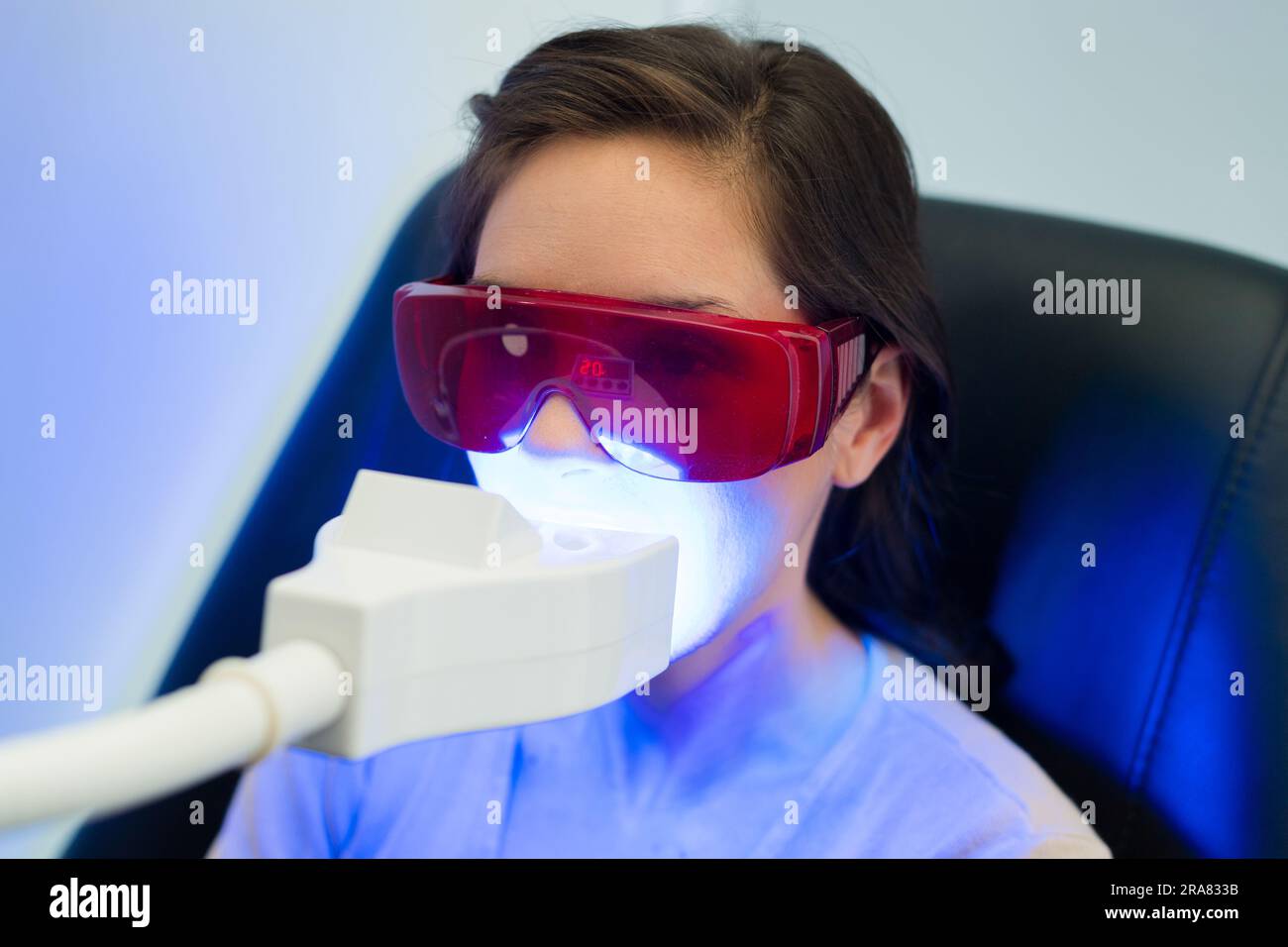 patient wearing protective eyeglasses during ultraviolet dental