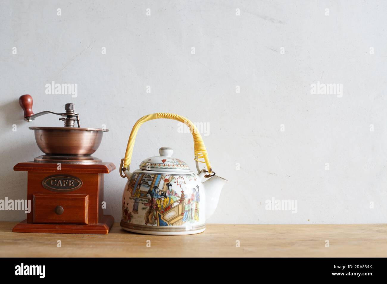 Vintage manual coffee grinder and ceramic traditional chinese tea pot