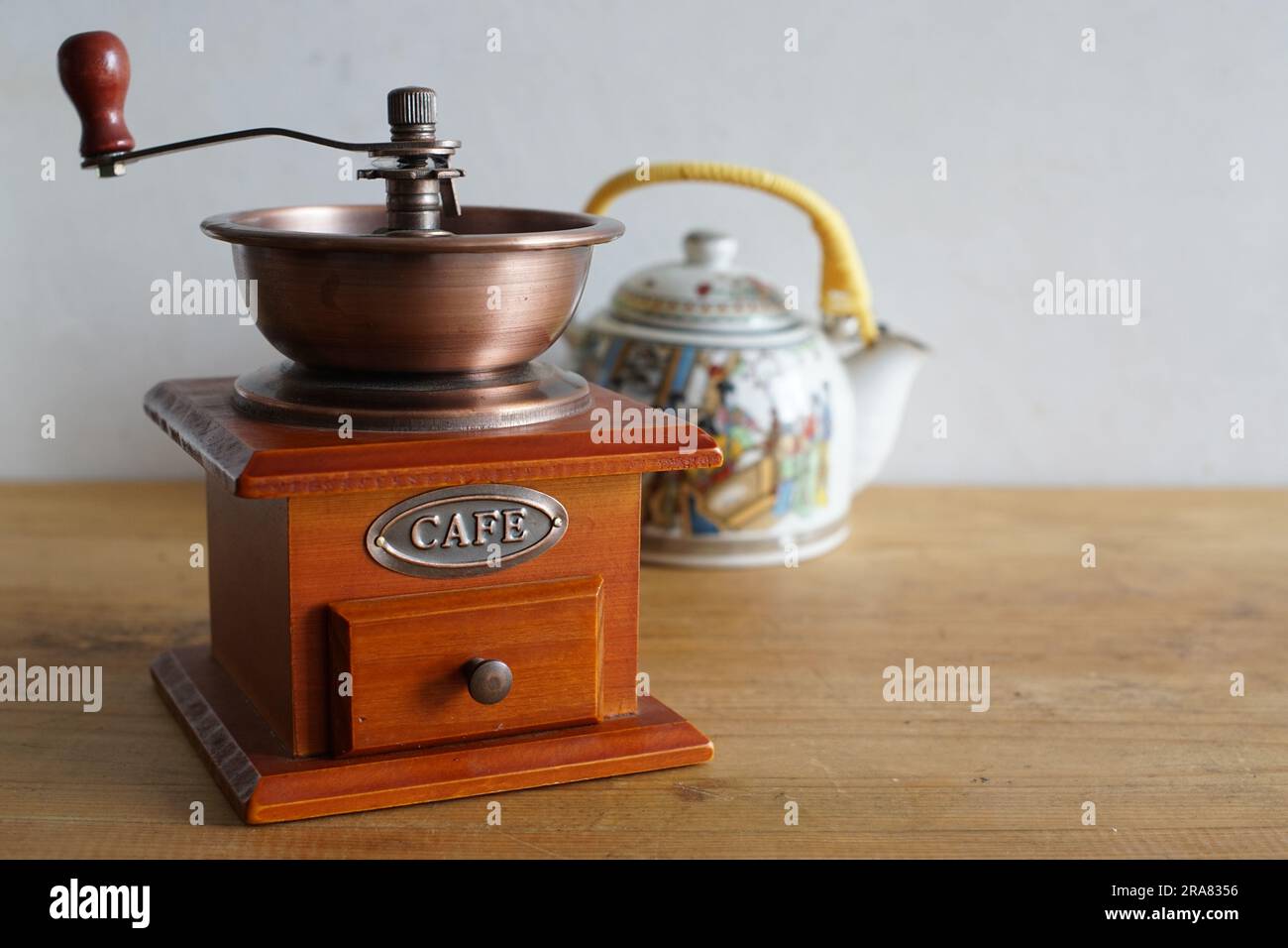 Vintage manual coffee grinder and ceramic traditional chinese tea pot