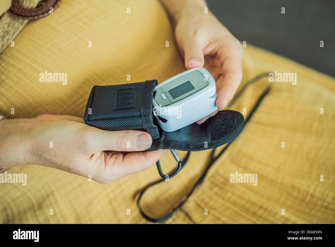 Pregnant woman with pulse oximeter on finger. Doctor measuring oxygen