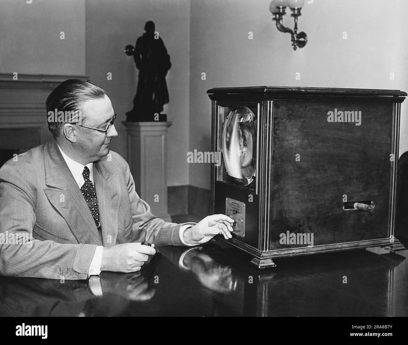 Washington, D.C.:  July 8, 1931 George Hastings, Secretary to President Herbert Hoover, examines a television receiver in his office at the White House. Stock Photo
