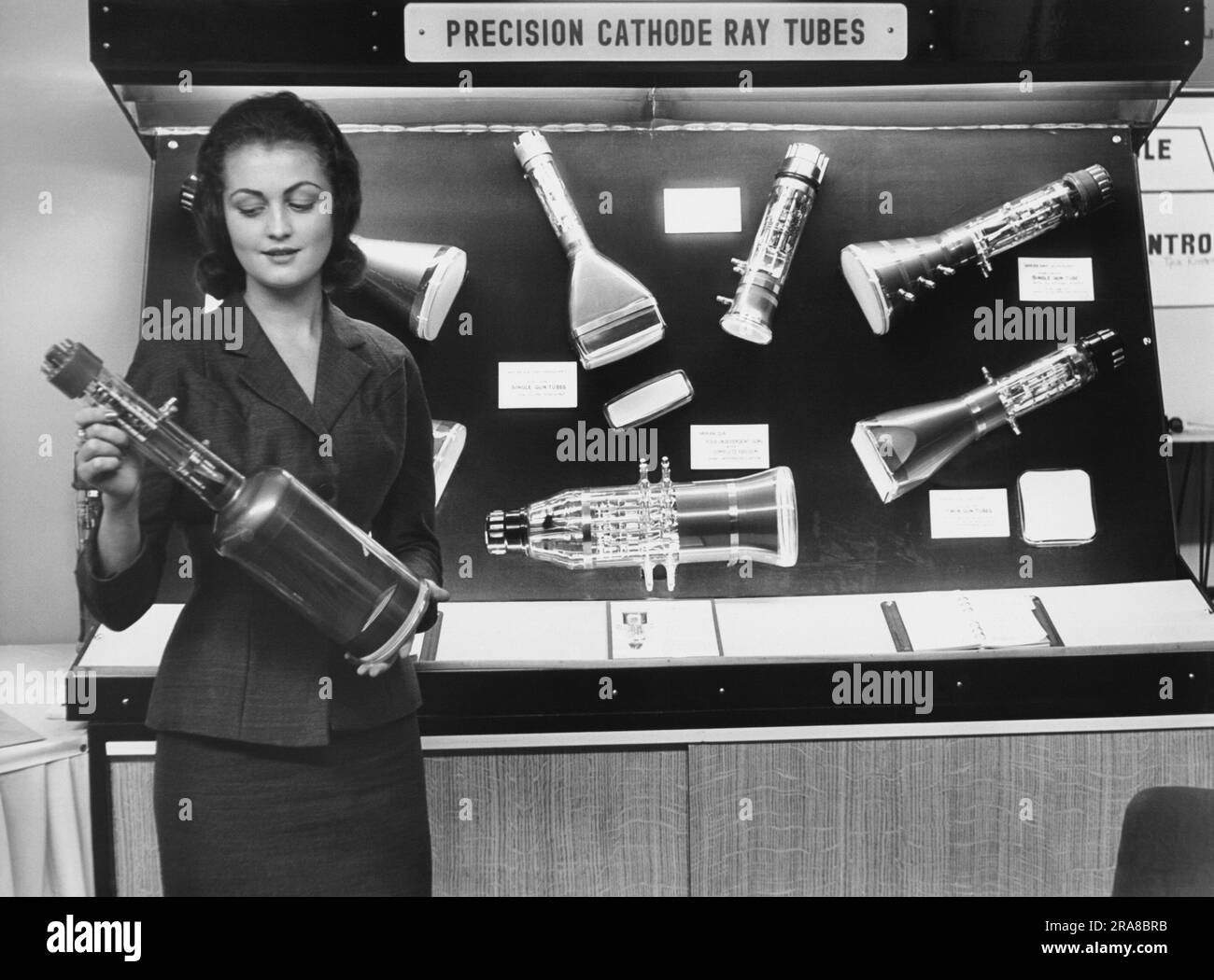 London, England:  1956 A woman holding a cathode ray tube for television. Stock Photo