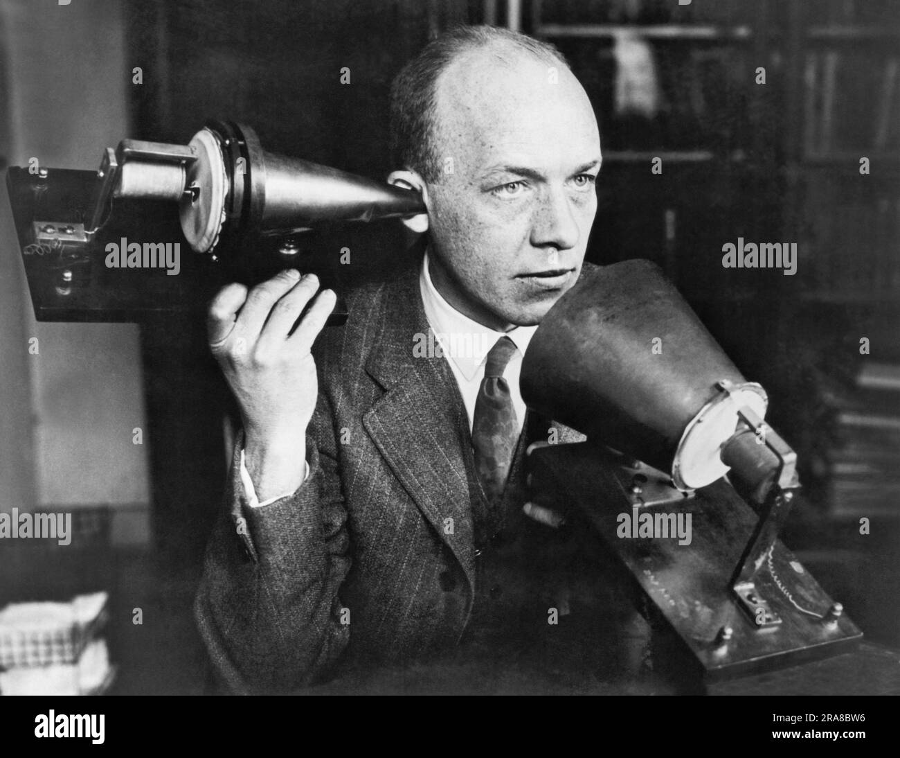 United States:  c. 1915 A man using one of Alexander Graham Bell's first telephones. Stock Photo