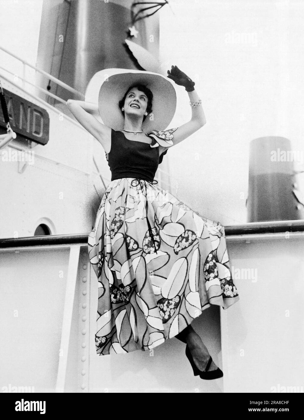 San Francisco, California:  April, 1949 Model Gloria Cohan on board a steamship wearing a summer silk Gibson Bayh design. Bayh was a custom fashion designer for Gump's, the luxury fashion and department store. Stock Photo