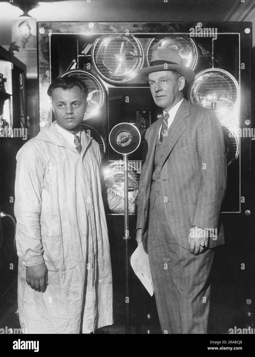 New York, New York:  c. 1931 Television pioneer Ulises Sanabria (left) at the eighth annual Radio-Electrical World's Fair with his revolutionary television apparatus that can project an image on a 10 foot screen Stock Photo