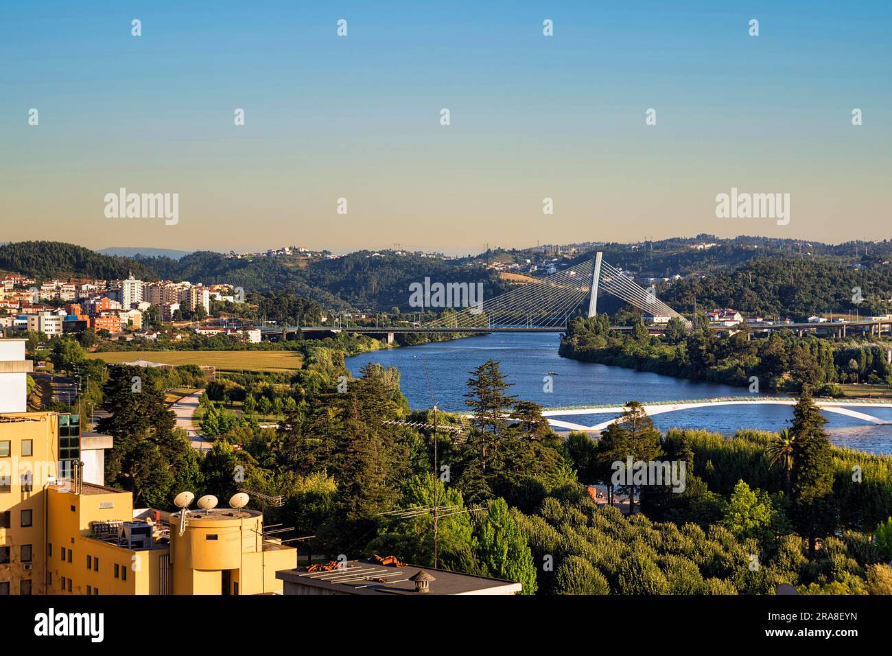View of Mondego River with Ponte Rainha Santa Isabel and Ponte Pedro e Ines, Old Town of Coimbra, Portugal Stock Photo