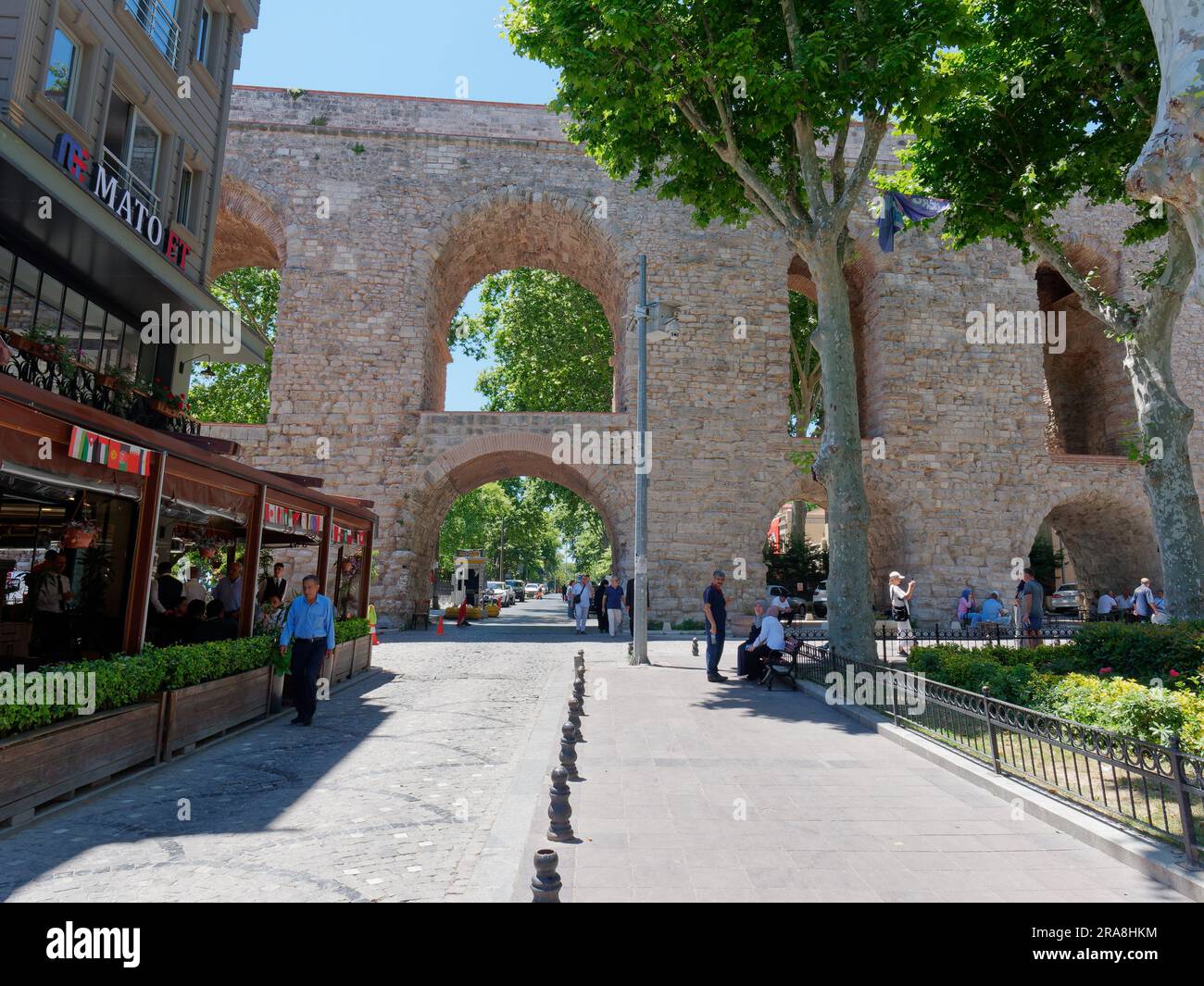 Street  and restaurant beside the Aqueduct of Valens, a Roman Aqueduct in Istanbul, Turkey Stock Photo