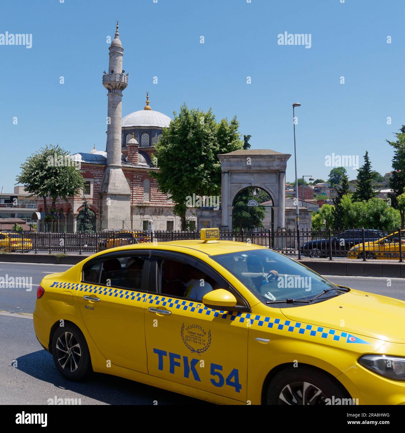 Yellow taxis on a road in front of a Mosque in Istanbul Turkey Stock Photo