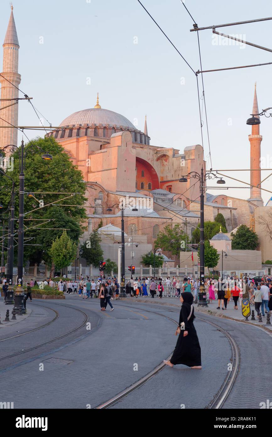 Street with tram tracks in the Sultanahmet neighbourhood on a summers evening with the Hagia Sophia behind, Istanbul, Turkey Stock Photo