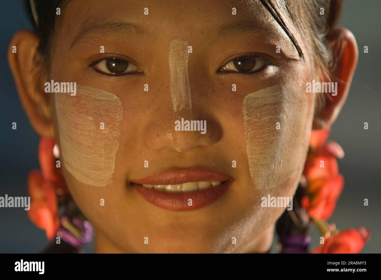 Young Burmese woman with Thanaka paste on her face, Amarapura, Burma