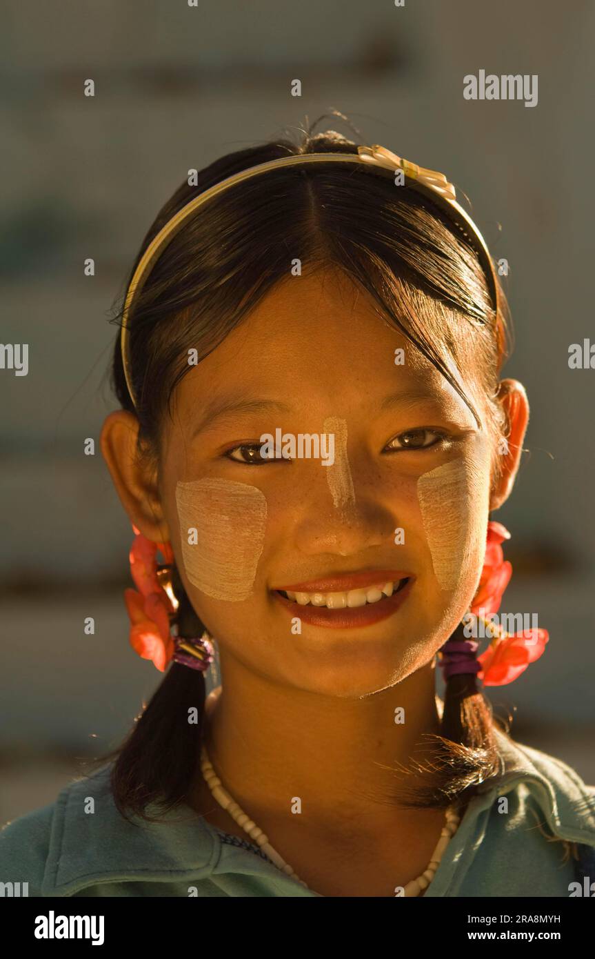 Young Burmese woman with Thanaka paste on her face, Amarapura, Burma