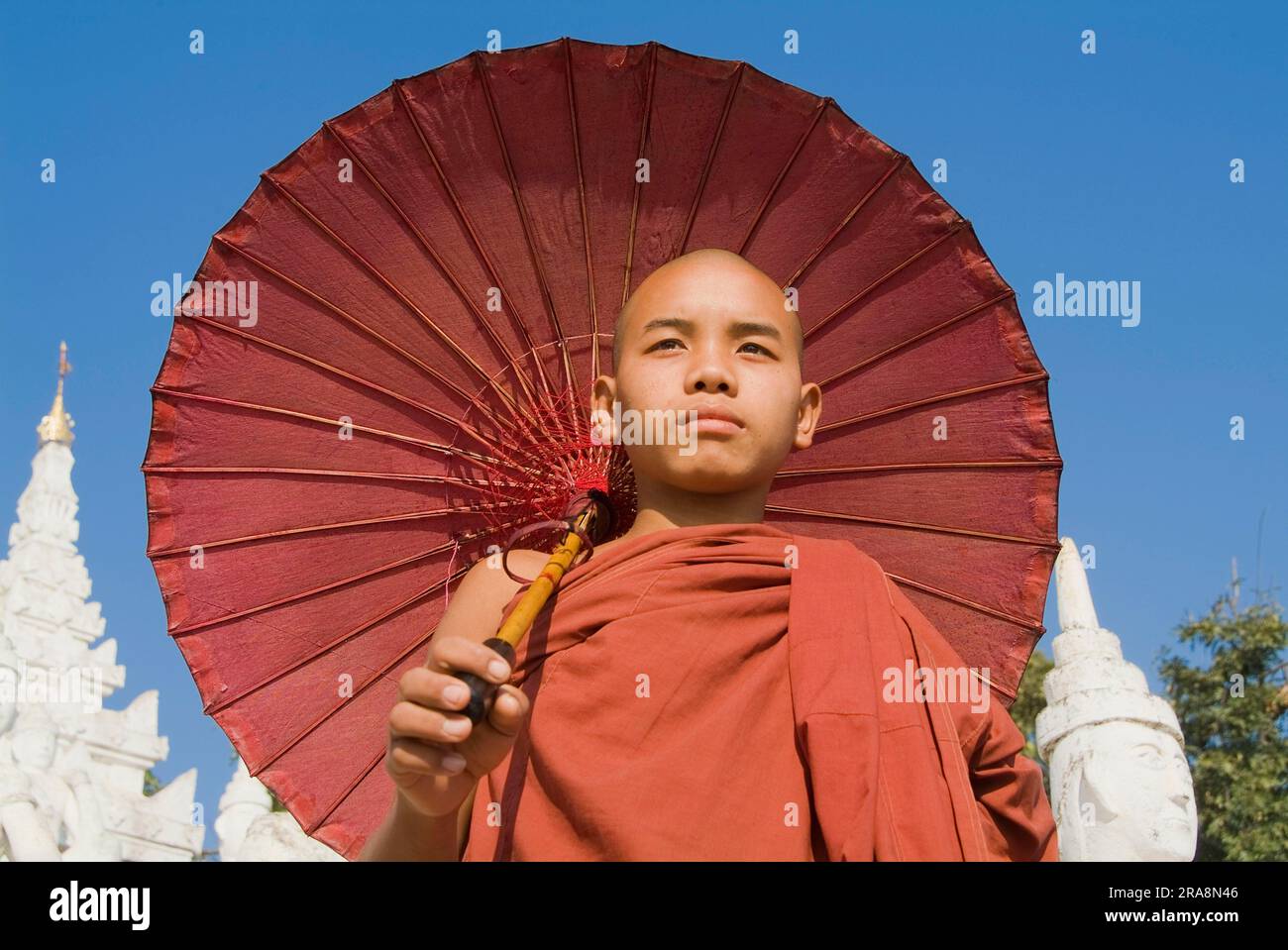 Young Buddhist monk with parasol, Set Taw Ya Pagoda, Mingun, Burma