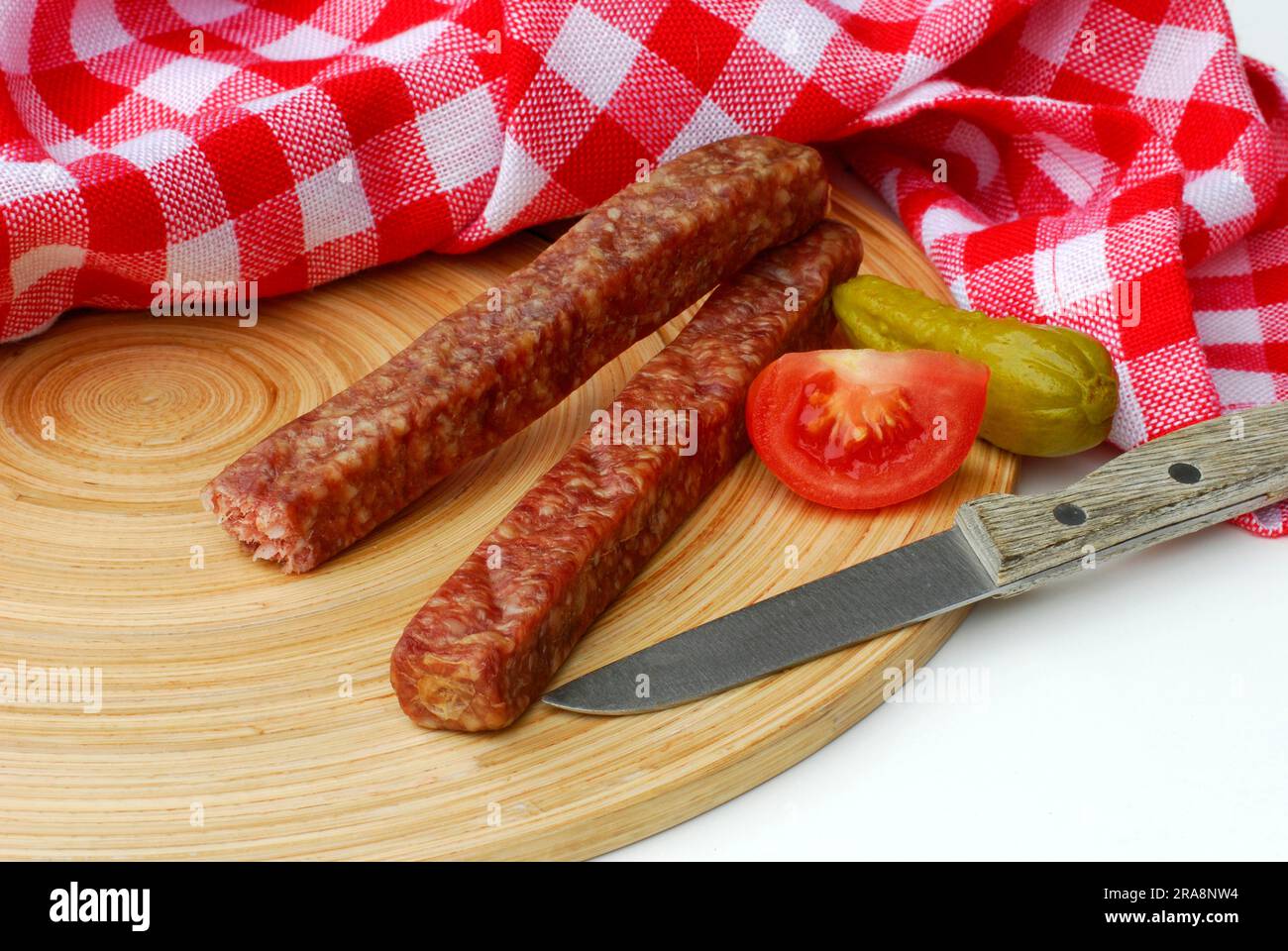 Mettwurst on wooden board and knife, Landjaeger, hard sausage, sausage Stock Photo