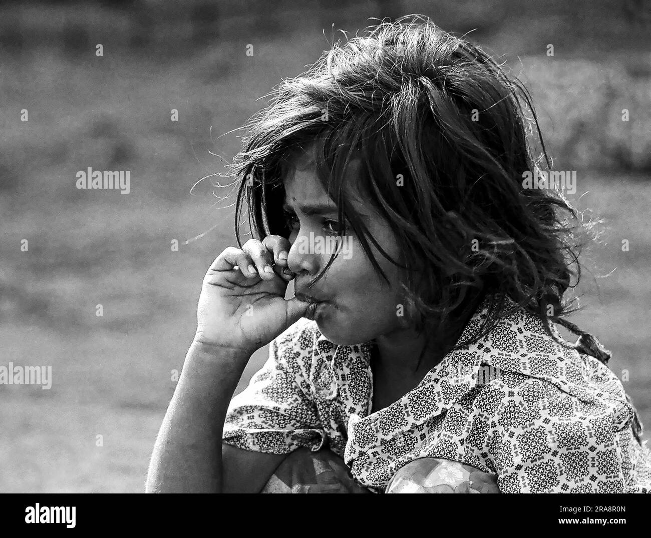 black and white photo, A girl sucking thumb in Coimbatore, Tamil Nadu, India, Asia Stock Photo