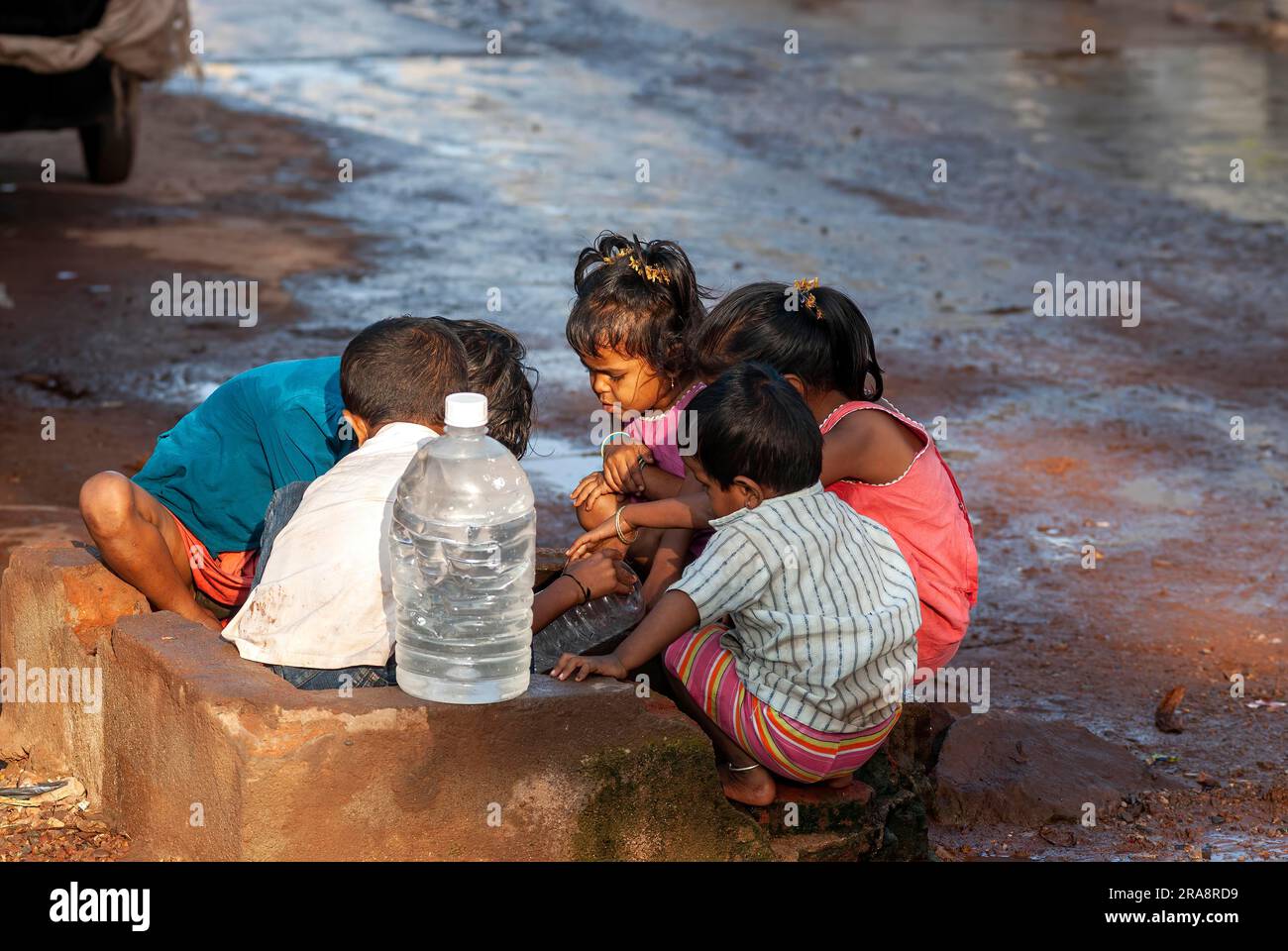 Childrens collecting water at Badami, karnataka, South India, India, Asia Stock Photo