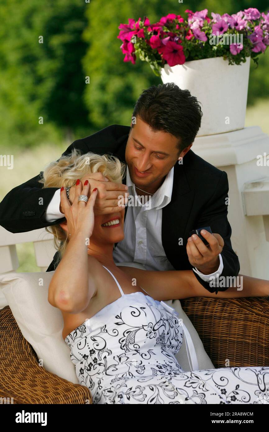 Man covers woman's eyes, surprise, marriage proposal Stock Photo Alamy