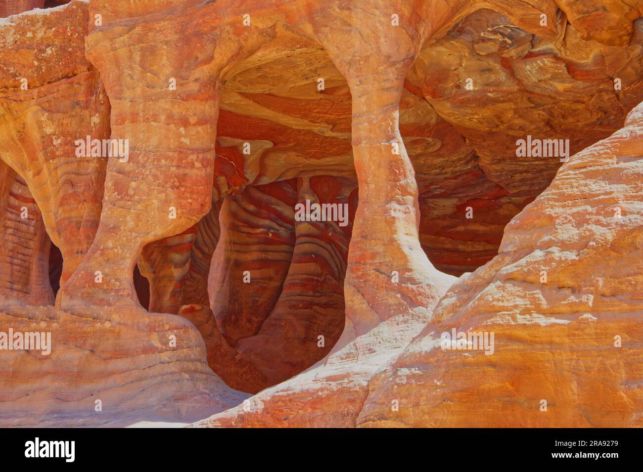 Natural cavity in petra with colorful gealogical  strata in red colors Stock Photo
