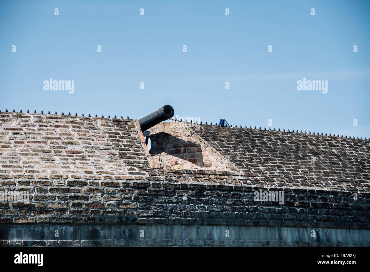 Vilnius, Lithuania - 06 05 2023: An old military cannon sticks out of the bastion of the Vilnius defence wall. Stock Photo