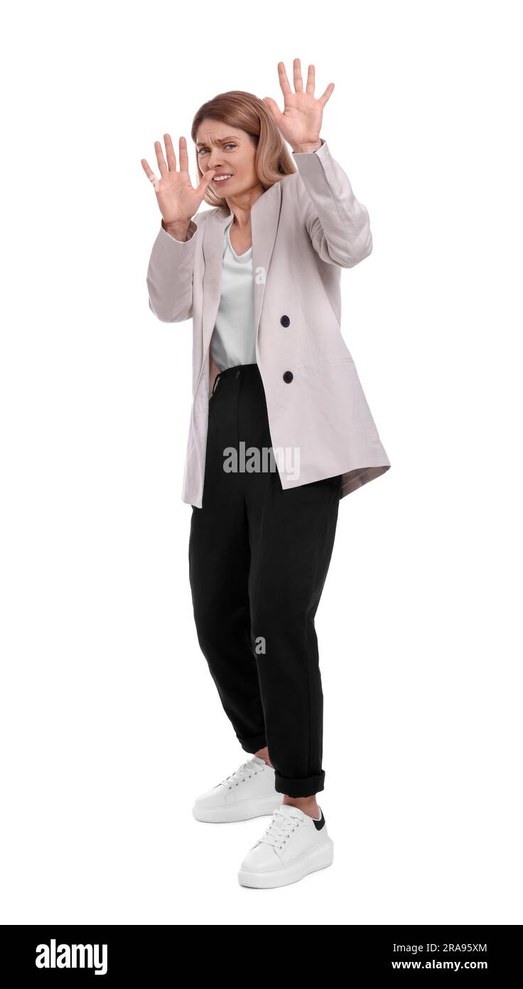 Beautiful businesswoman avoiding something on white background Stock Photo