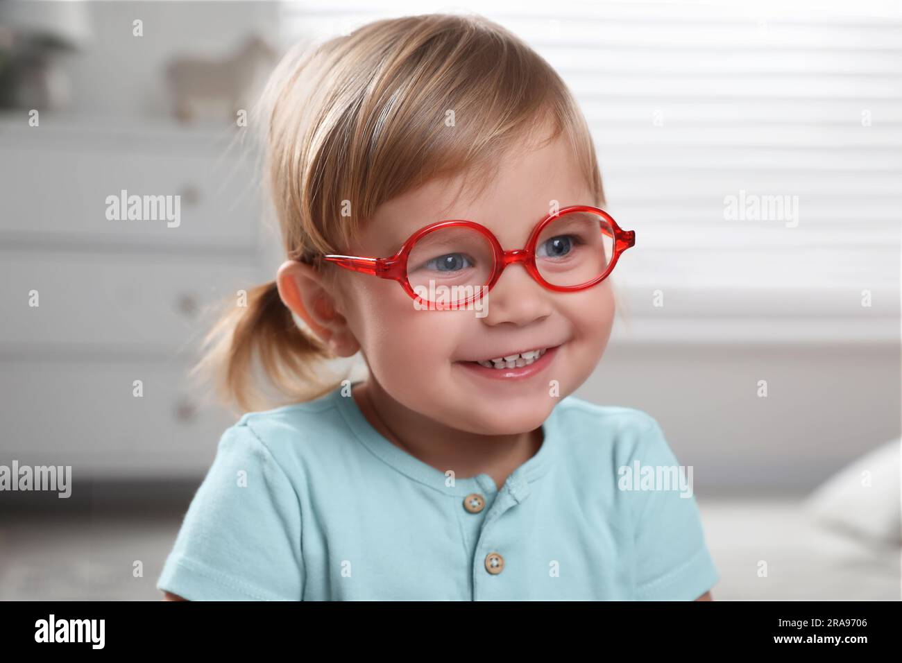 Cute little girl in glasses at home Stock Photo Alamy