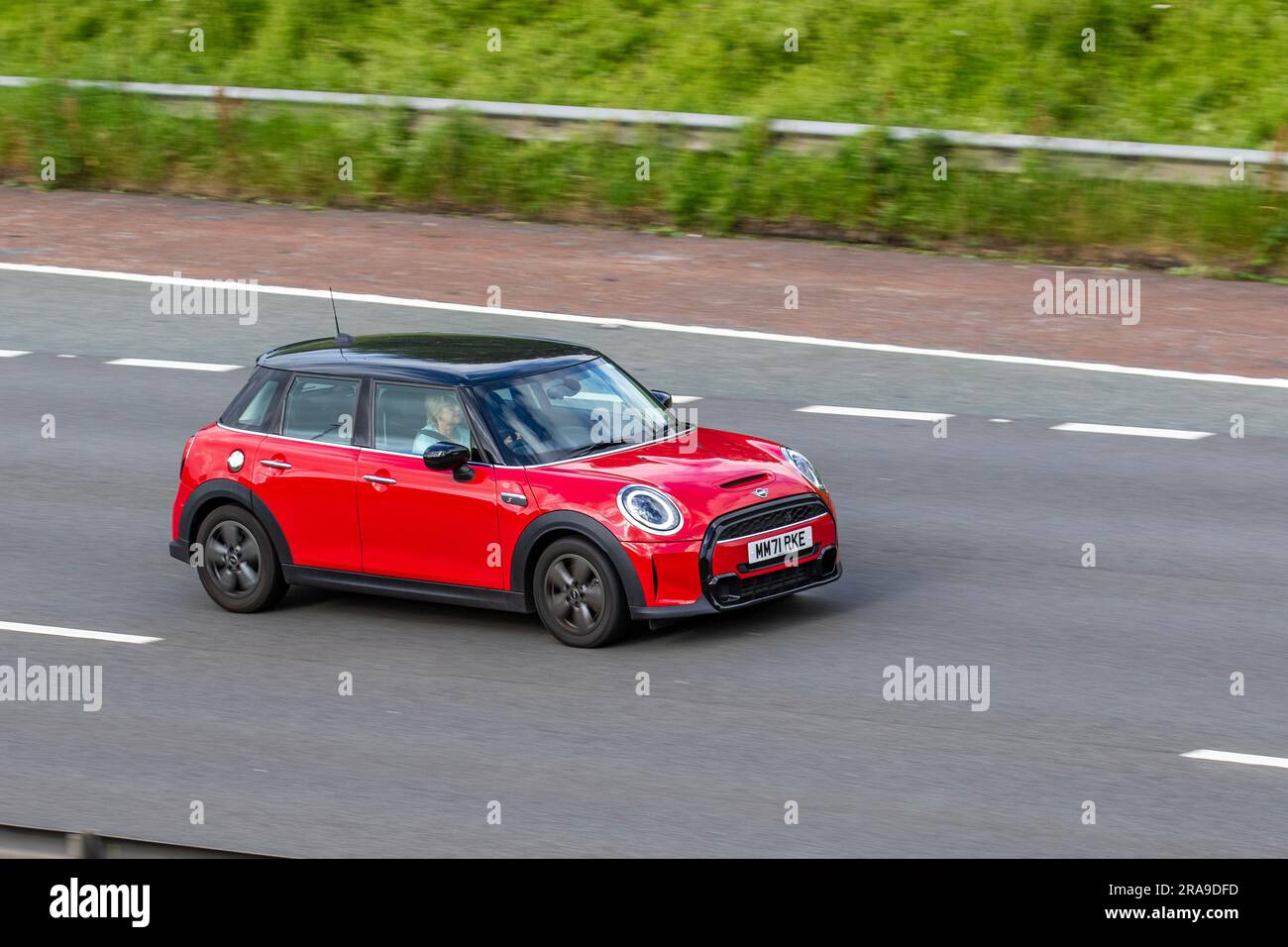 2023 Mini Cooper S Classic Auto 178 Steptronic Auto Start/Stop Red Car Hatchback Petrol 1998 cc; travelling at speed on the M6 motorway in Greater Manchester, UK Stock Photo