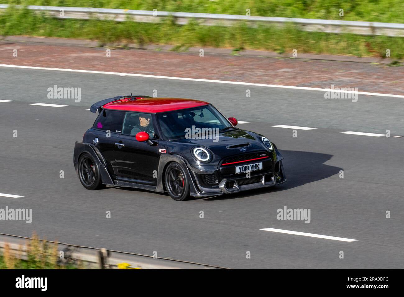 2018 Black Mini John Cooper Works Auto Steptronic Auto Black Car Hatchback Petrol 1998 cc; travelling at speed on the M6 motorway in Greater Manchester, UK Stock Photo