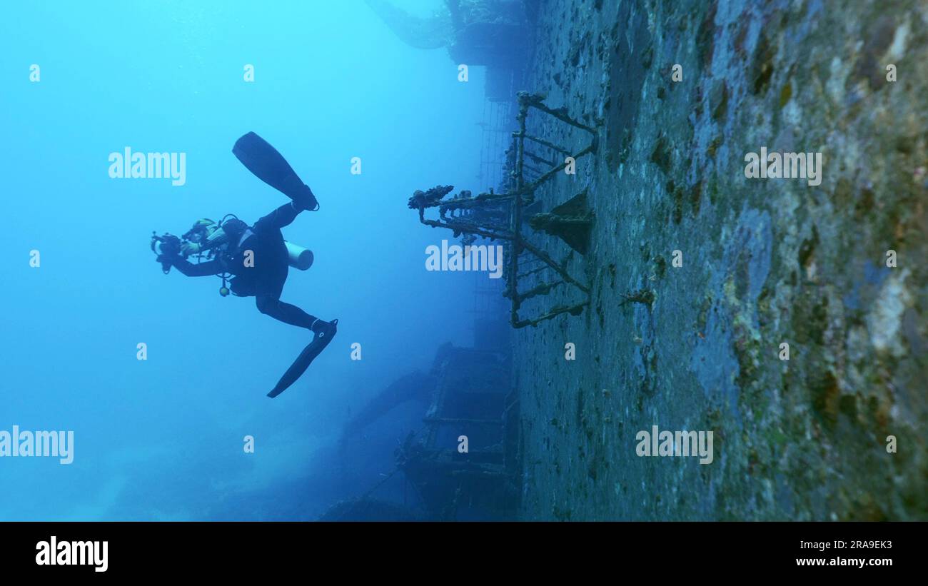 Scuba diver swim and filming along deck of ferry Salem Express