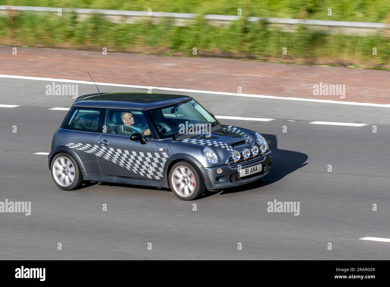 2004 Mini Cooper S Grey Car Hatchback Petrol 1598 cc; travelling at speed on the M6 motorway in Greater Manchester, UK Stock Photo