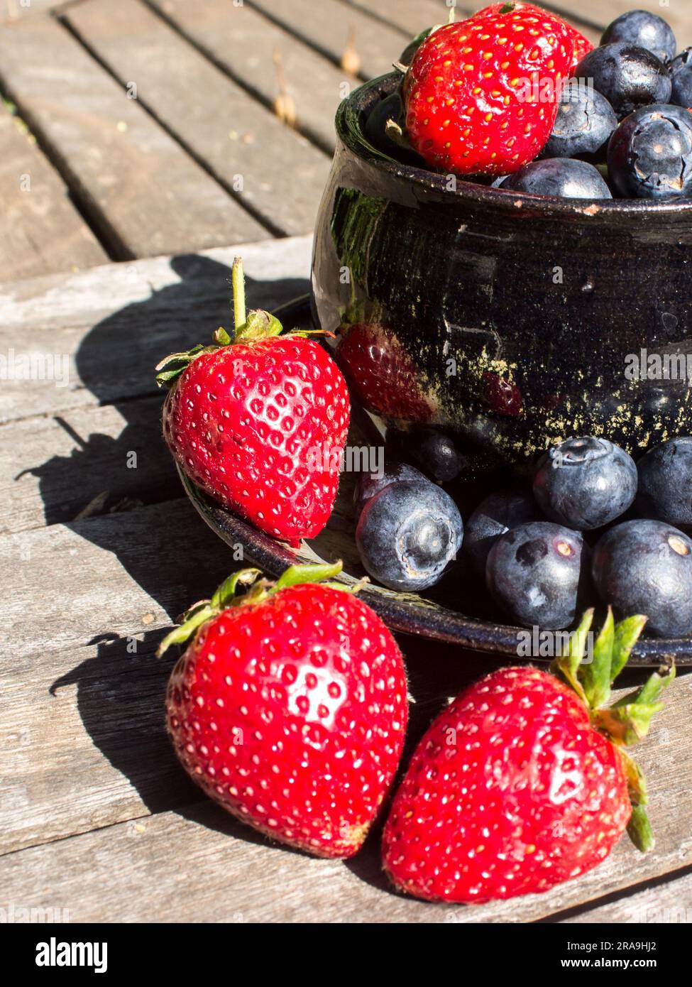 Overflowing abundance of Strawberries and Blueberries Stock Photo