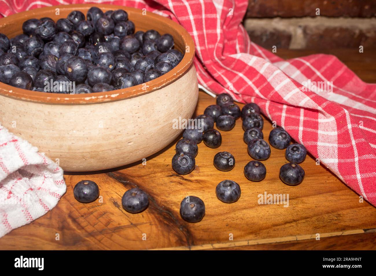 A rustic bowl filled with blueberries Stock Photo