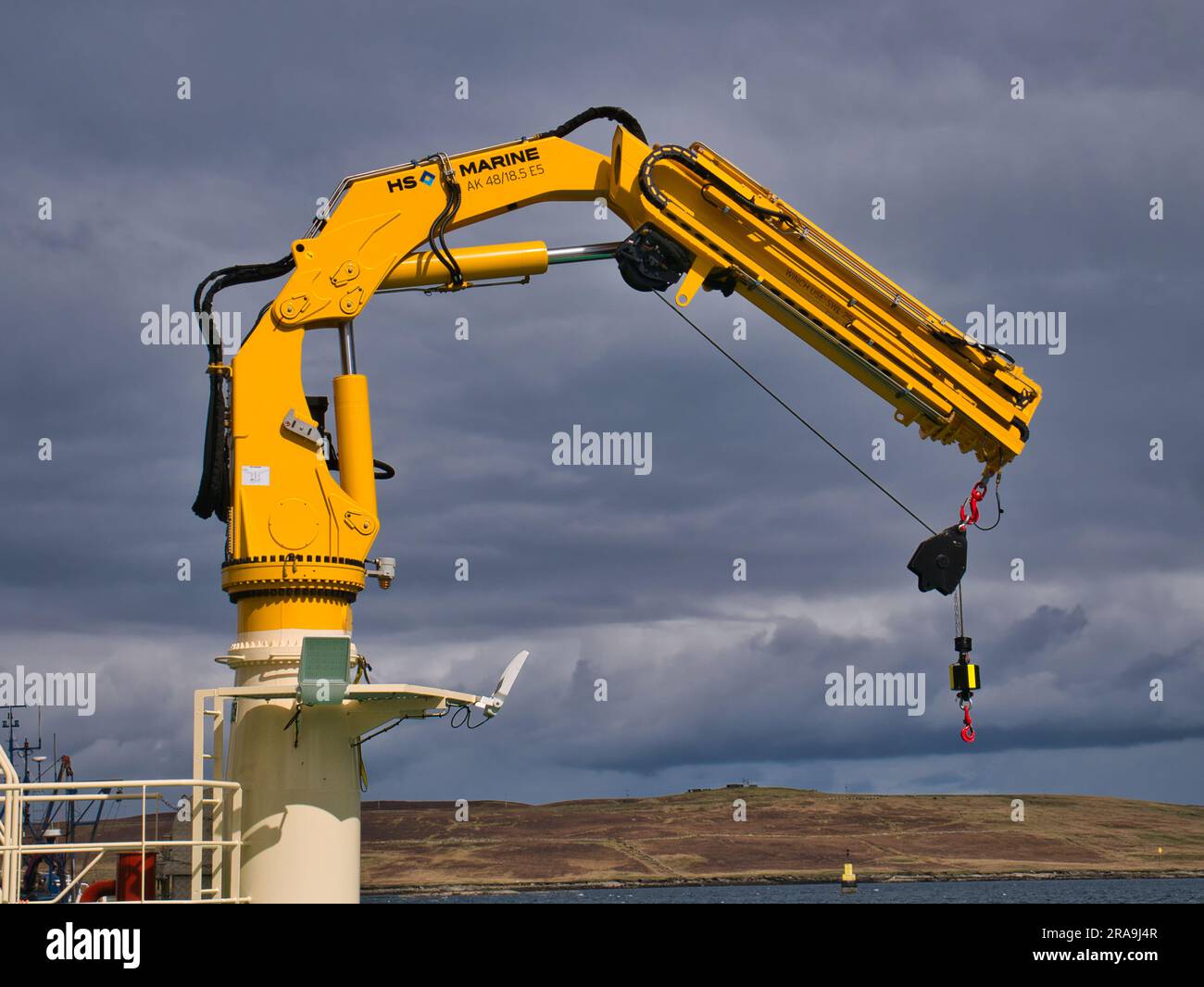 A yellow HS Marine AK 4818.5 fully foldable knuckle and telescopic boom