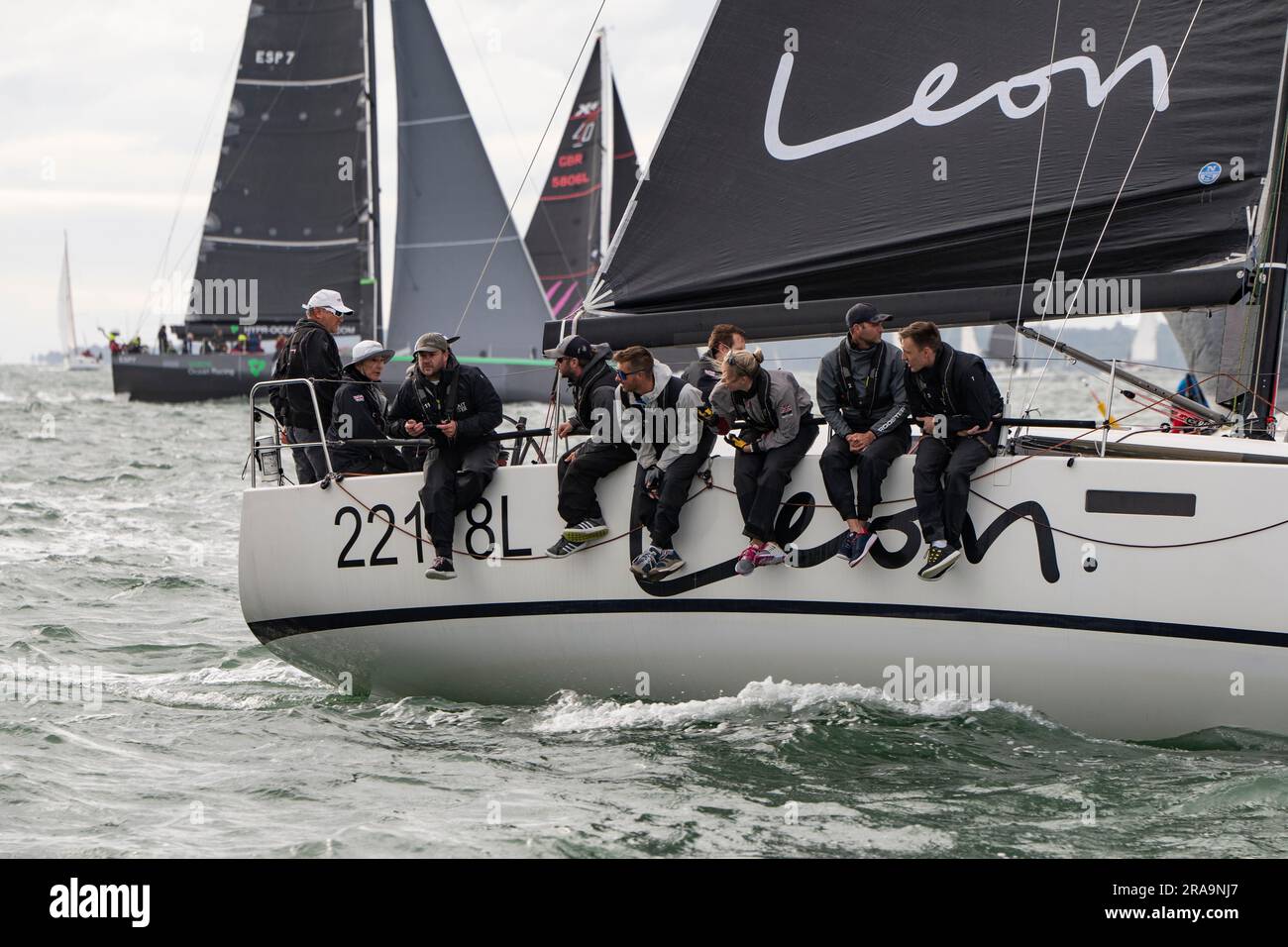 Crew of Sailing Yacht GBR22118L Leon on their way to a class victory at the Isle of Wight Round The Island Sailboat race on the South coast of England Stock Photo