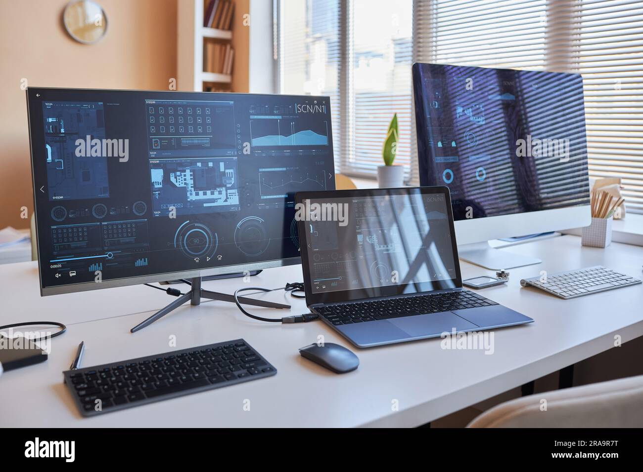 Row of three desktop computers with online graphic data on screens ...