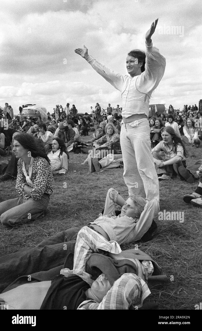 Stonehenge Free Festival at the summer solstice, June 21st. Celebrating the music a live band is on stage - free pop festival - Wiltshire, England circa June 1976. 1970s UK HOMER SYKES Stock Photo