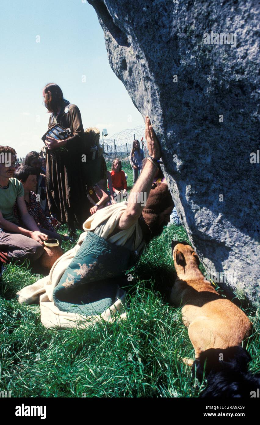 Bev Richardson known as Pagan Bev, a 1970s style hippie worshiping to the pagan gods at a Stone. Stonehenge Free Festival at the summer solstice, Wiltshire, England June 21st 1979. 70s UK HOMER SYKES Stock Photo