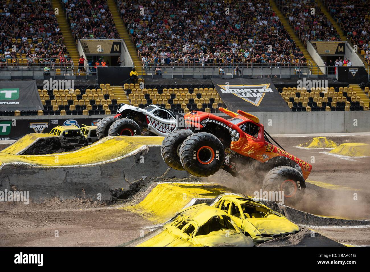 Dresden, Germany. 02nd July, 2023. (L-r): Monster truck 'MONSTER MUTT DALMATIAN' and 'EL TORO LOCO' jumping over ramps at the monster truck show 'Monster Jam' at the Rudolf Harbig Stadium in Dresden, Germany Credit: Paul Glaser/dpa/Alamy Live News Stock Photo