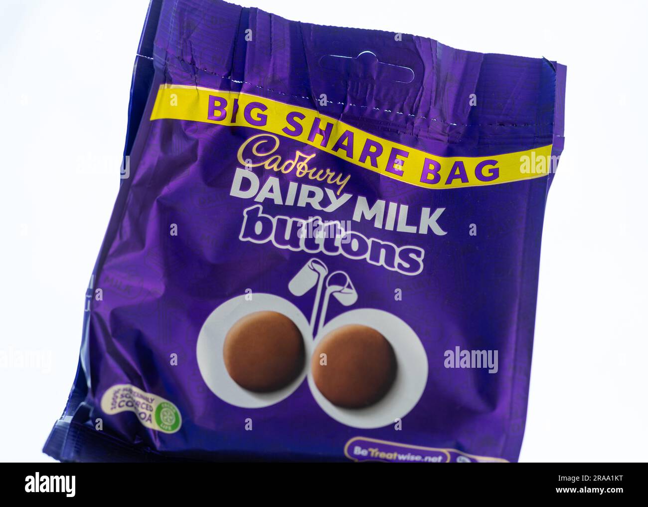 Pack of Cadbury Dairy Milk chocolate buttons white background Stock