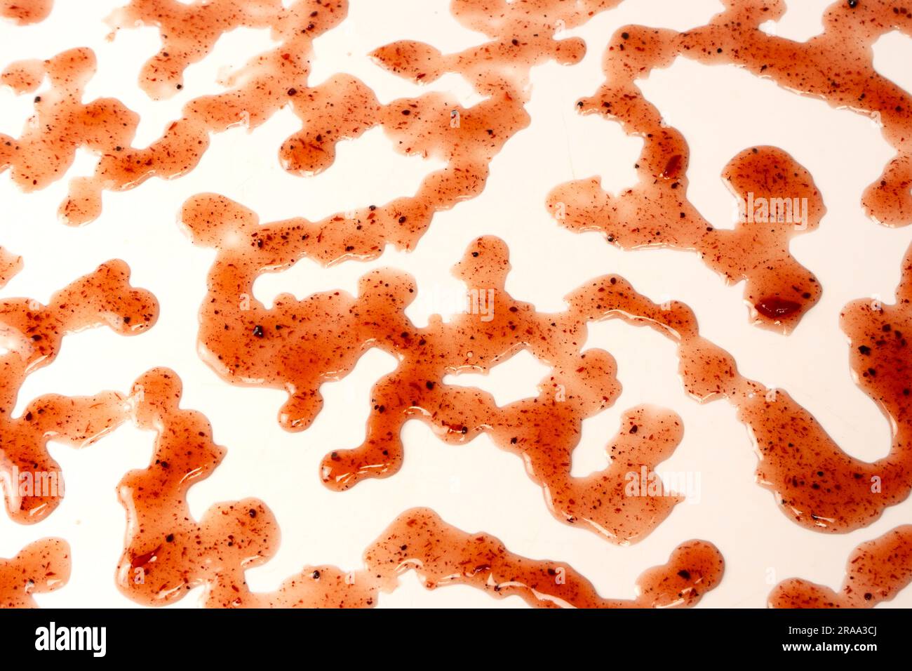 Red jam splashes isolated on a white background. Top view. Stock Photo