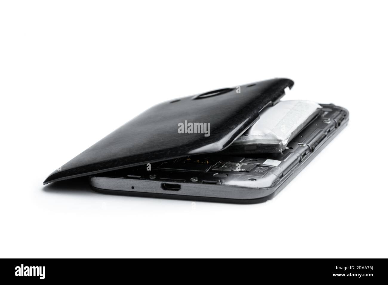 Smartphone destroyed by exploded lithium battery isolated on white