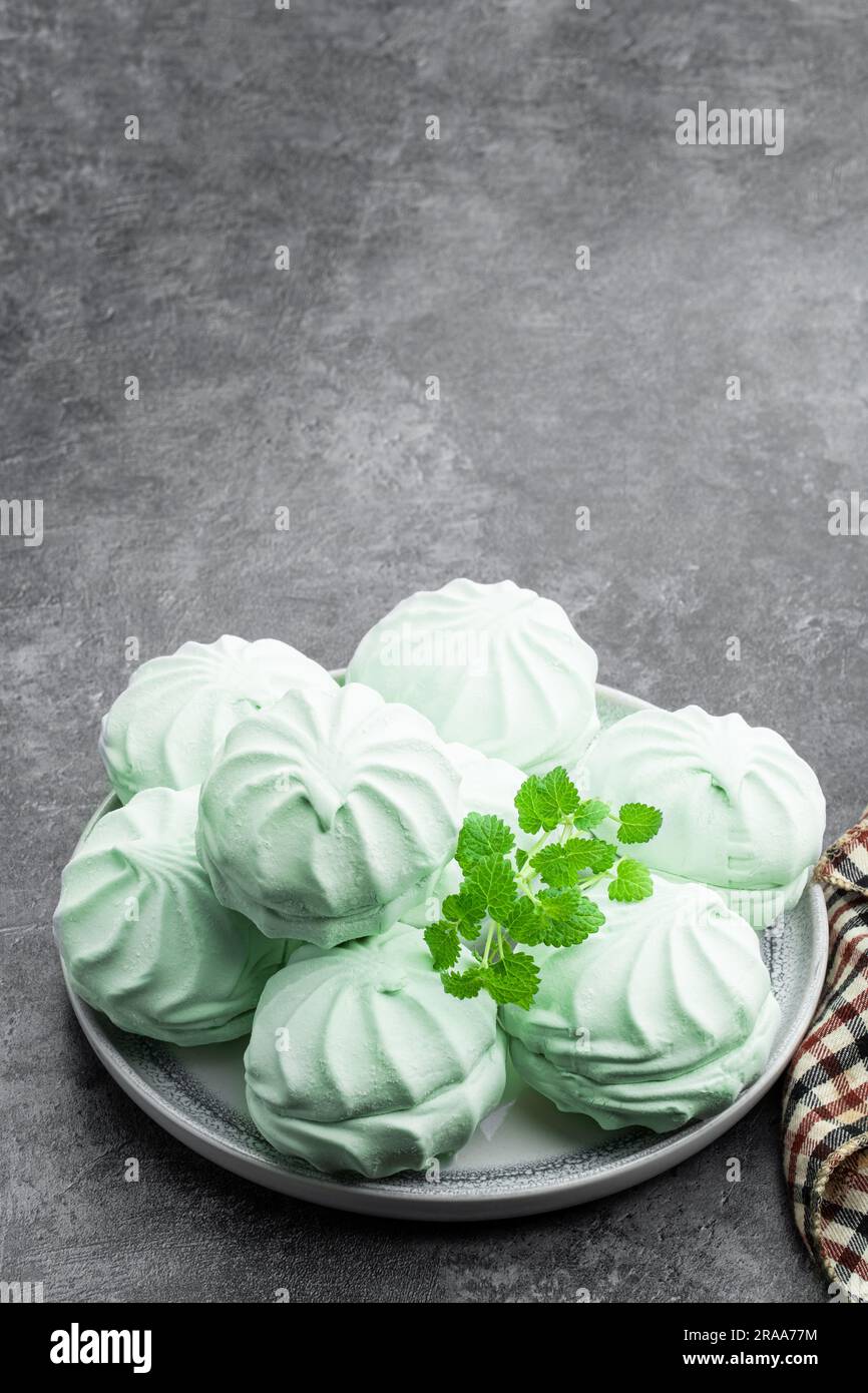 Mint  marshmallows on ceramic plate on gray background Stock Photo