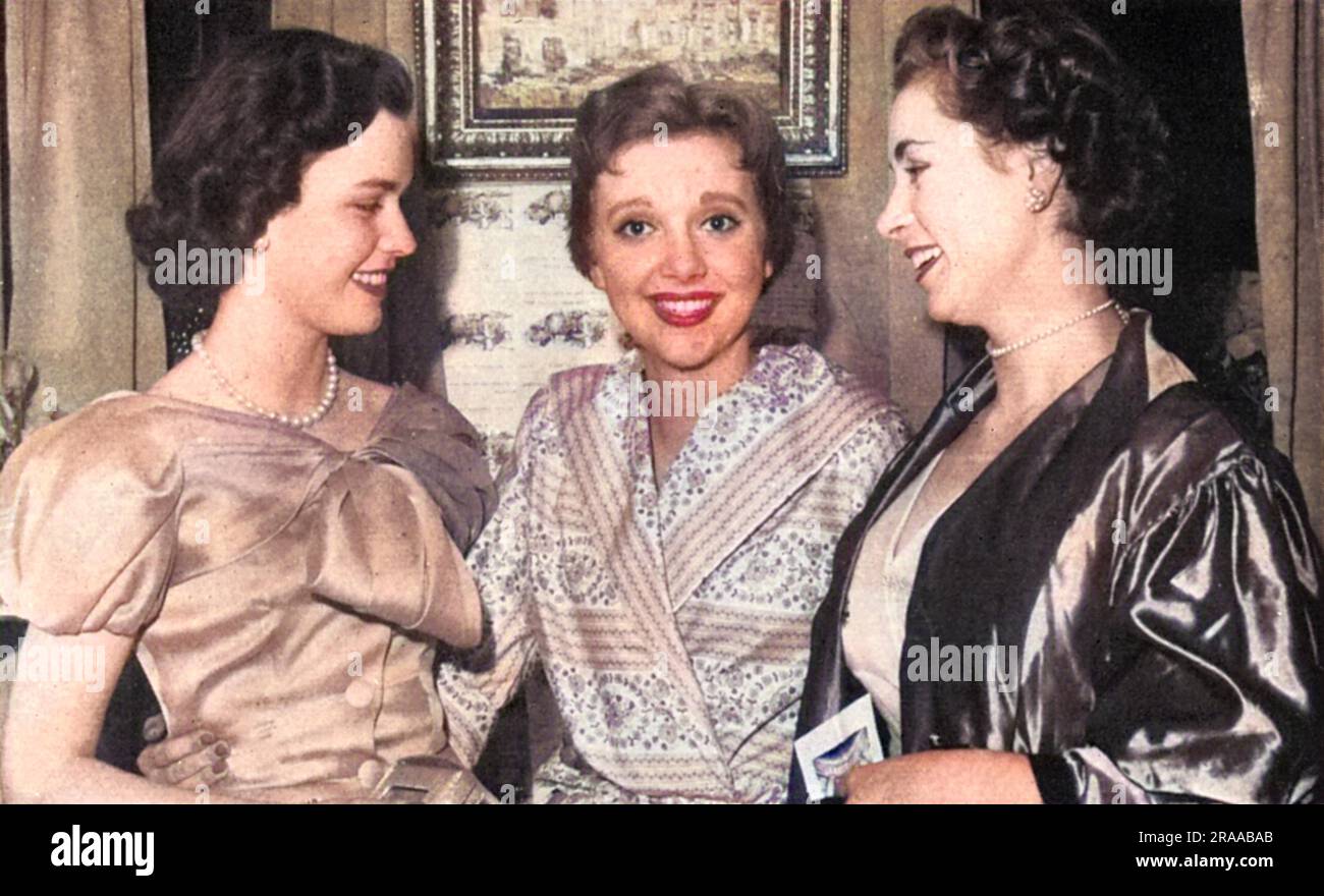 Miss Anna Massey (1937 - 2011), English actress, pictured flanked by her fellow debutantes Miss Frances Sweeny (left) and Miss Camilla Straight.  She was starring in the successful play by William Douglas-Home, The Reluctant Debutante, which took a farcical look at the London Season and the keen interest mothers of society girls took in finding a husband for their debutante daughters.  Massey had been presented at court herself that year, but chose the stage rather than 'doing' the Season.  Frances Sweeny was the daughter of the Duchess of Argyll, the former Miss Margaret Whigham who had been Stock Photo