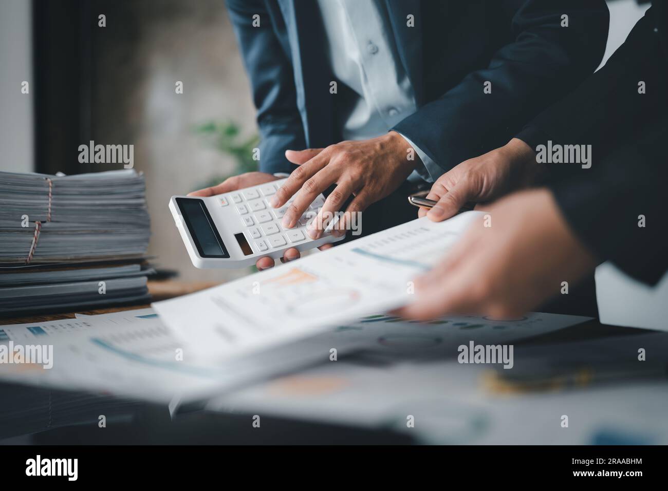 Accountant checking financial statement or counting by calculator ...