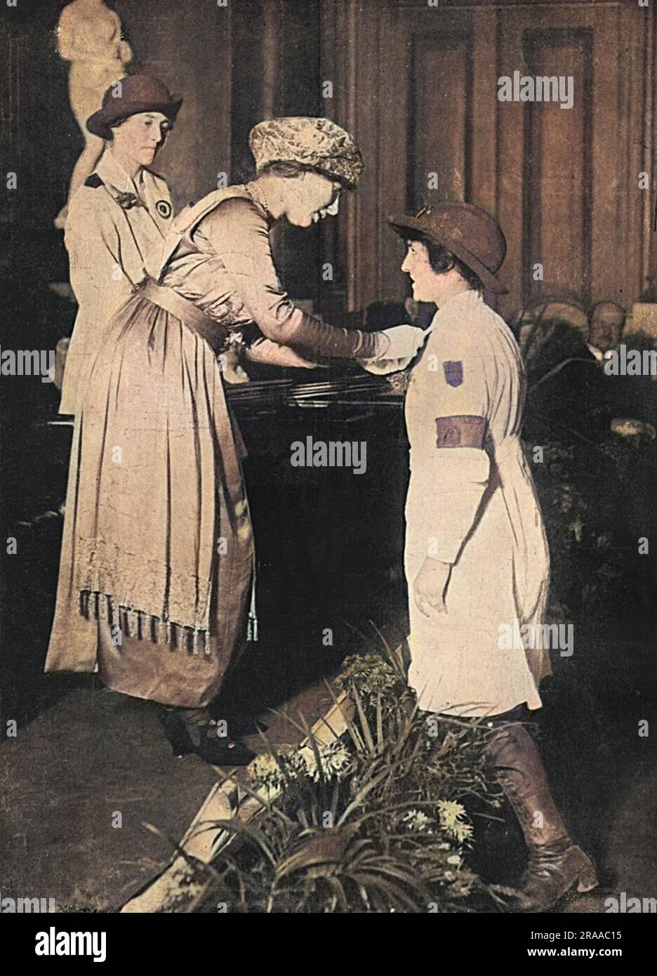 Princess Mary presenting medals to Land Girls in December 1919 at the Draper's Hall, at their last rally before demobilisation.  Fifty five women were awarded Distinguished Service Bars for deeds of bravery whilst in charge of horses, cattles and the like.  Pictured is Miss Ascanio being decorated by the Princess.     Date: 1919 Stock Photo