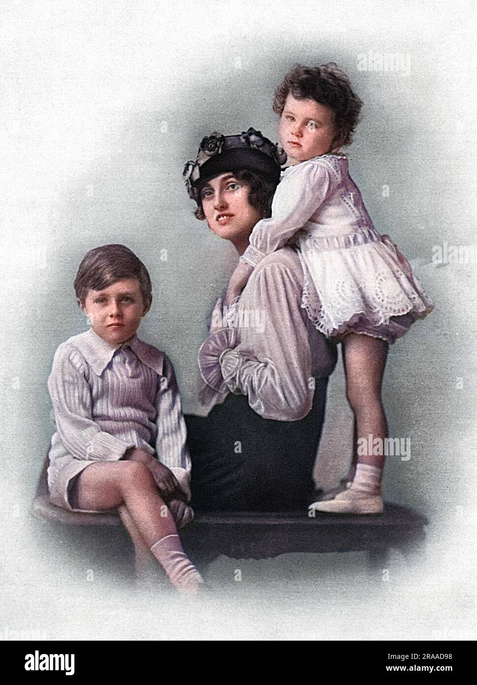 Countess Poulett, formerly the actress Sylvia Storey (1889-1947) remembered as a Gibson Girl and for her role of Lady Hamilton in, 'The Gay Gordons.'  Married the 7th Earl Poulett in 1908 and pictured with her children, Viscount Hinton and Lady Bridgett Poulett, born 1909 and 1912 respectively.  She was the daughter of Fred Storey the well-known comedian, one of Leslie-Farren-Storey group in the days of Gaiety burlesque.  Earl Poulett was an officer in the Royal Horse Artillery (Territorials) and succeeded his father as 7th Earl in 1899.  He died of influenza in the epidemic of 1918.  His son Stock Photo