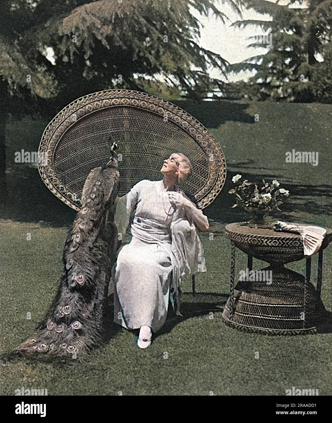 Ruth Saint Denis (1879 - 1968), modern dance pioneer, introducing eastern ideas into the art. She was the co-founder of the American Denishawn School of Dance and the teacher of several notable performers.  Pictured at home, in her garden in California with her pet peacock.     Date: 1917 Stock Photo