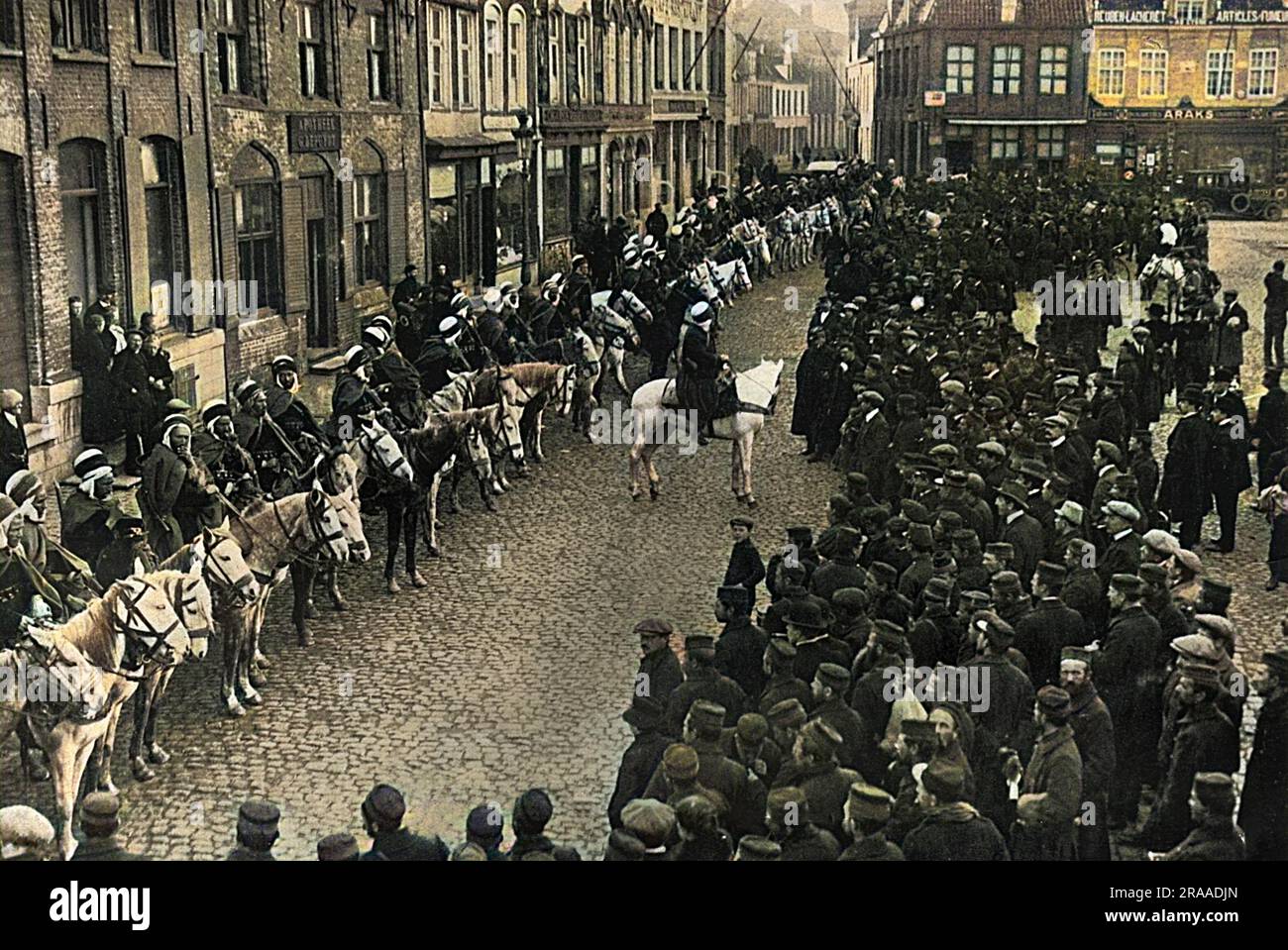 French Algerian cavalry - spahis drawn up in the market square at Furnes, West Flanders, Belgium, November 1914. Belgian people taking a keen interest.     Date: 1914 Stock Photo